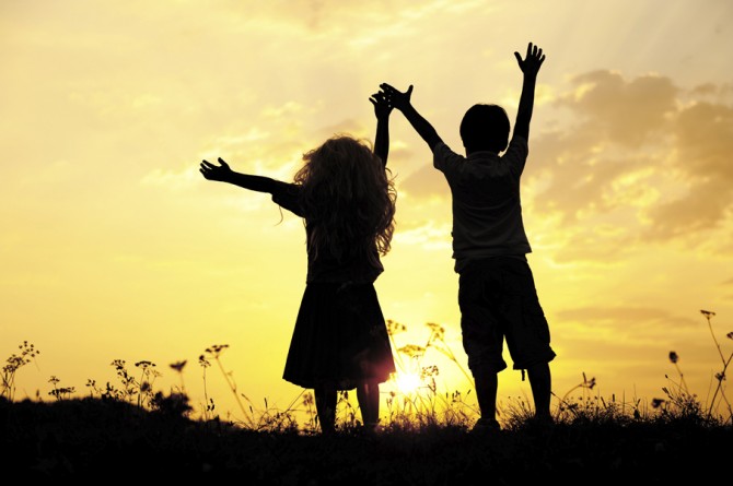 Silhouette, group of happy children playing on meadow, sunset, s